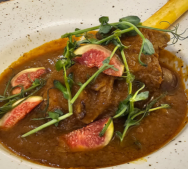lamb dish with fig slices and microgreens served in rich sauce 3 delicious flavors 3 gourmet herbs 3 fresh ingredients