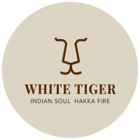 logo of White Tiger restaurant featuring a minimalist lion face design with text that reads White Tiger Indian Soul Hakka Fire showcasing unique cuisine options for diners